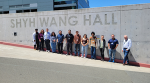a row of people in front of a building