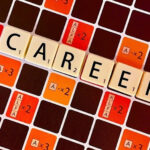 the letters CAREER on a Scrabble board